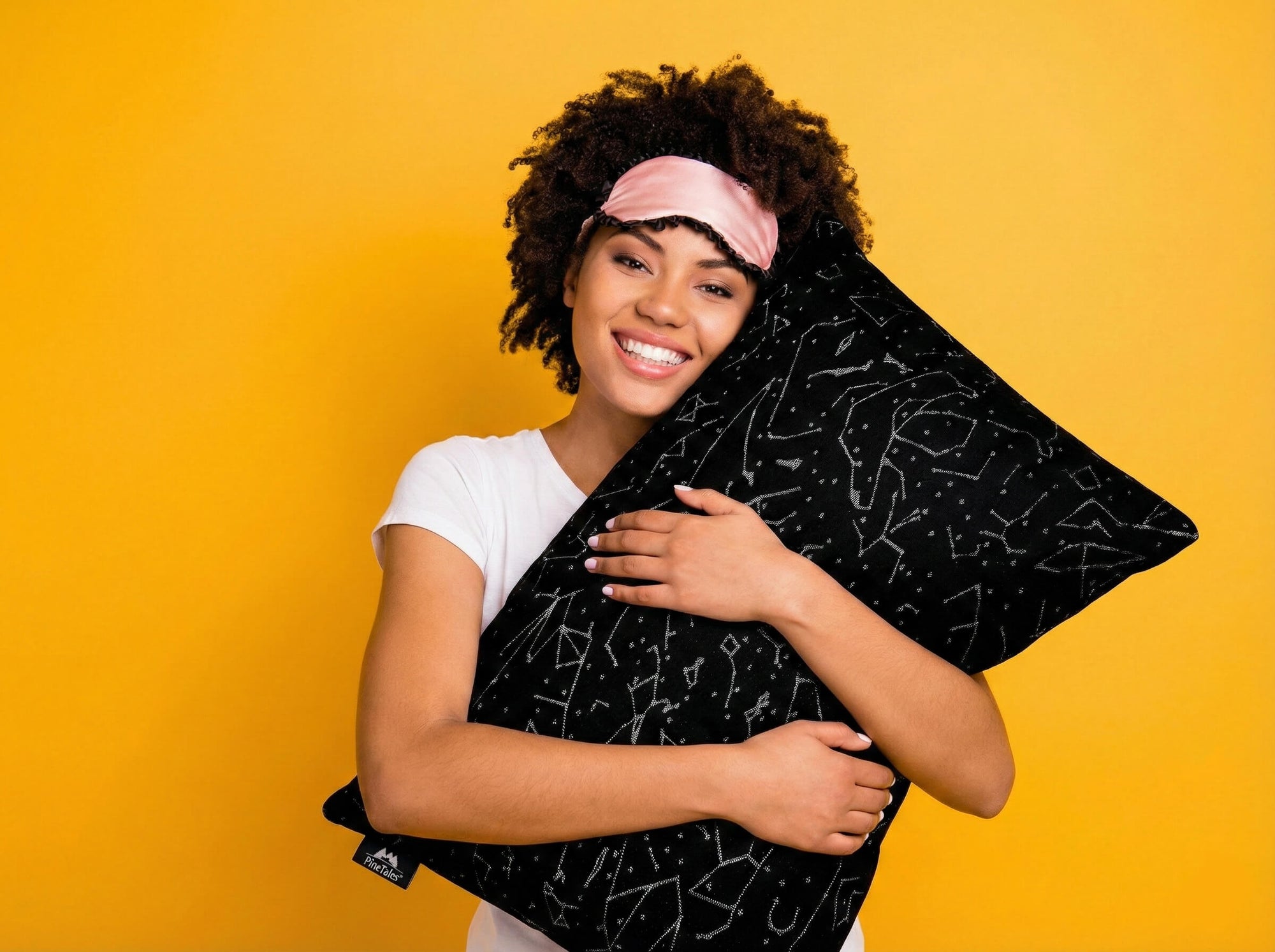 Young happy woman hugging a PineTales Buckwheat Pillow