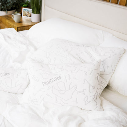 White comforter with PineTales platinum buckwheat pillows on a boutique style bed