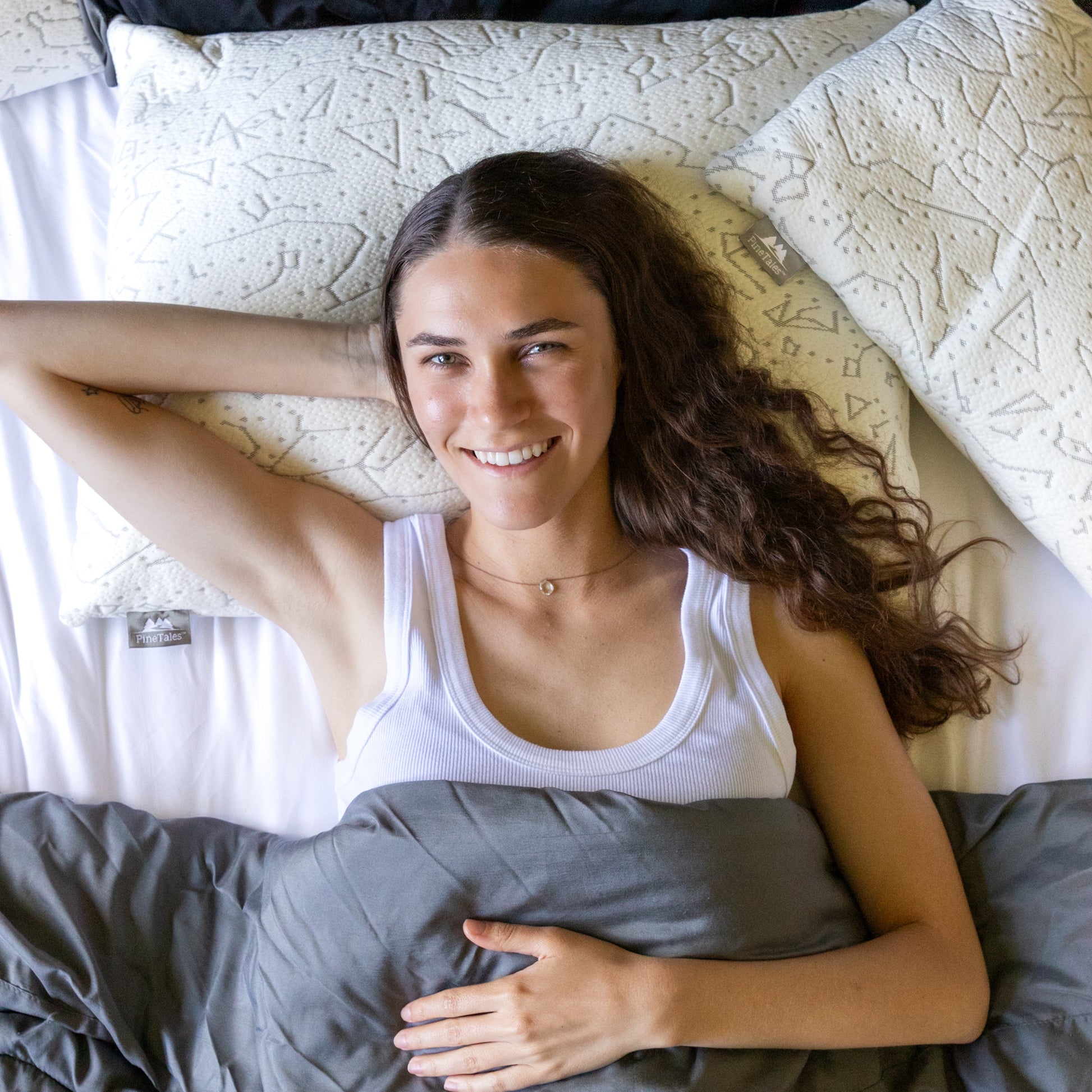 Young woman resting her head on a 20 by 26 inch premium buckwheat pillow  filled with 100% buckwheat hulls, demonstrating the pillows' superior support