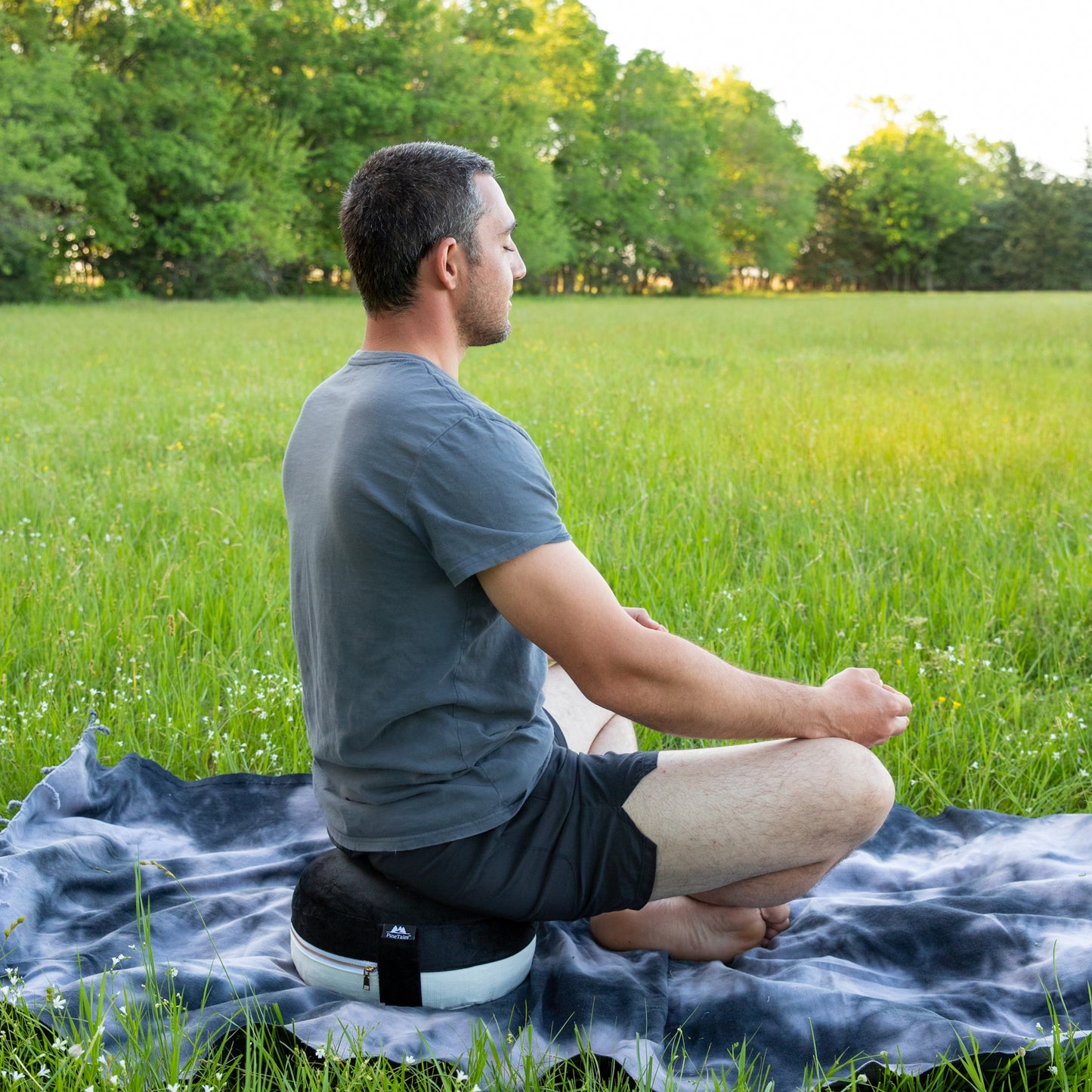 Meditation Pillow - Zafu Edition in Premium Design used outdoors on blanket over grass