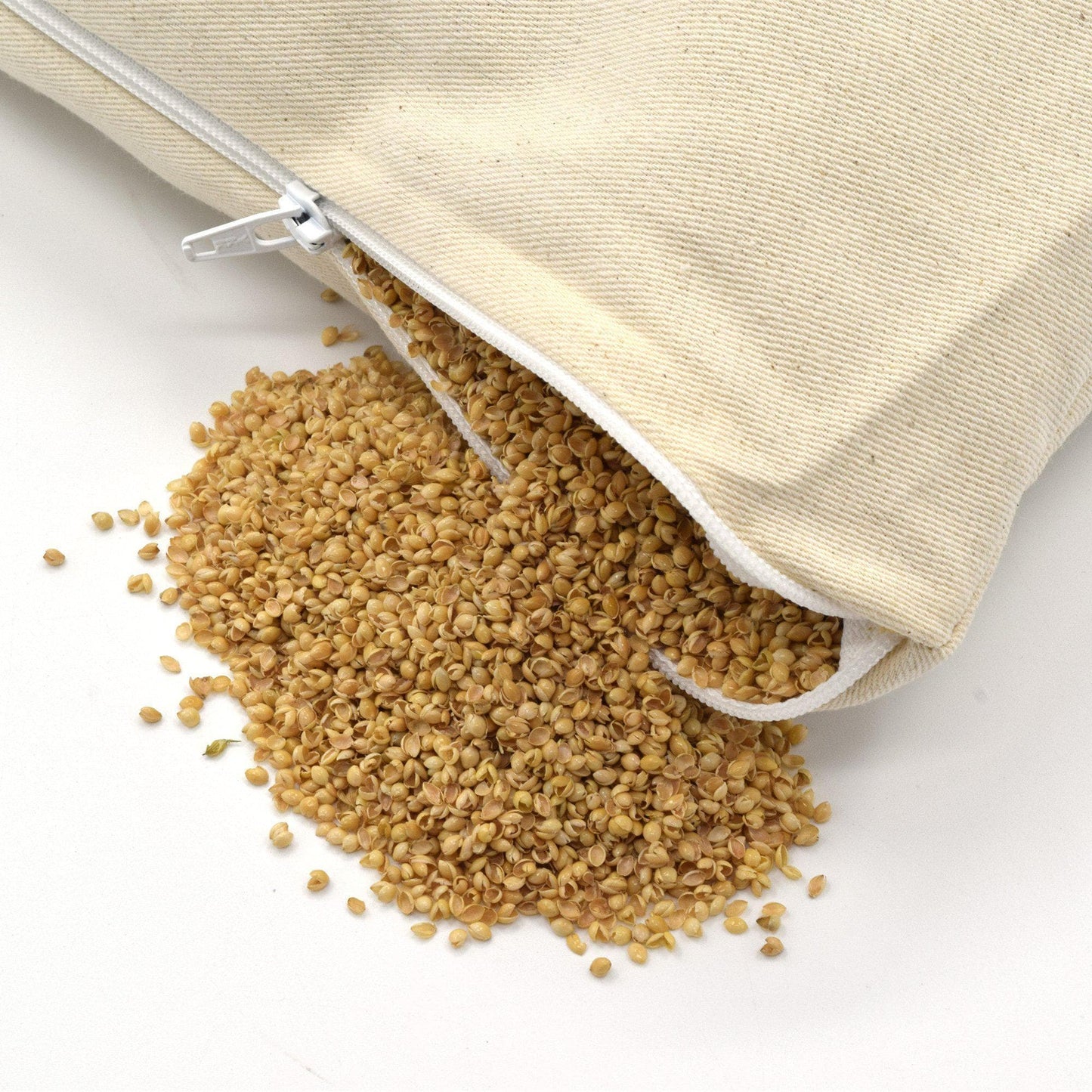 PineTales Cotton Twill Millet Pillow with open zipper showing the millet hulls filling