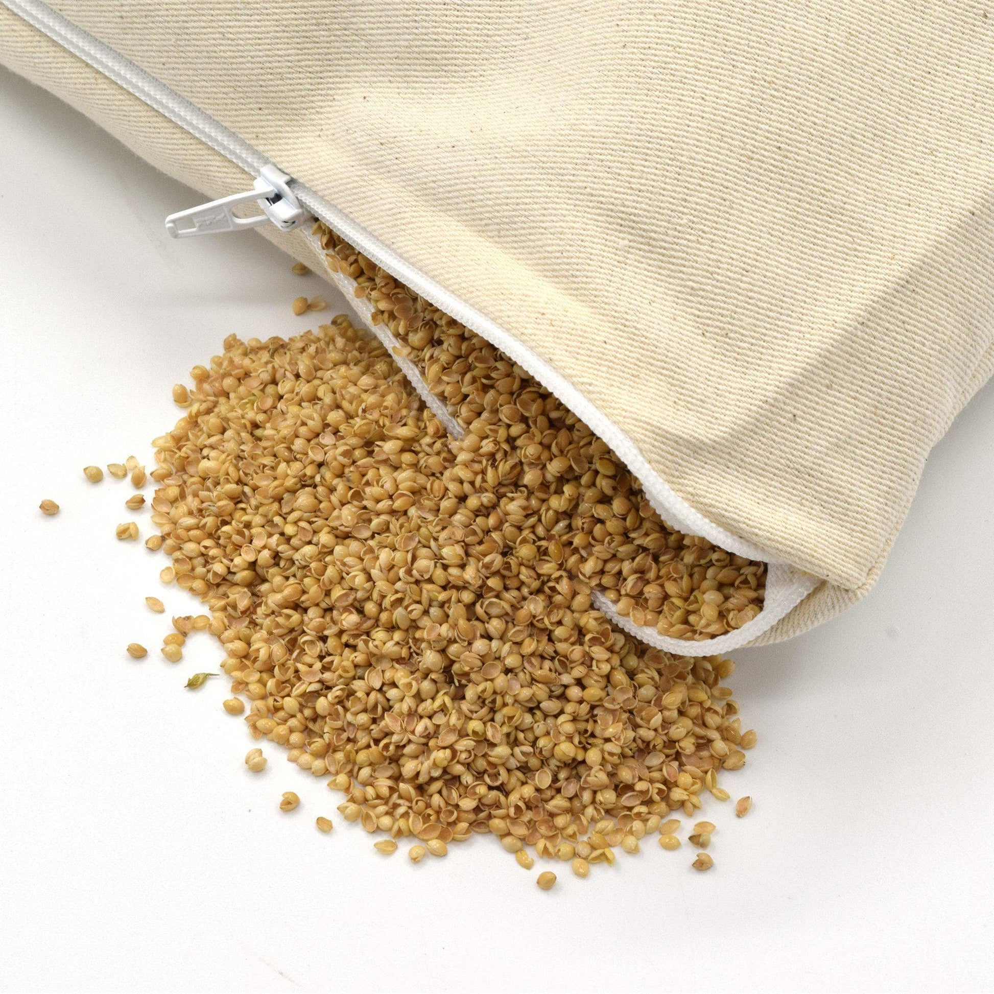 PineTales Cotton Twill Millet Pillow with open zipper showing the millet hulls filling