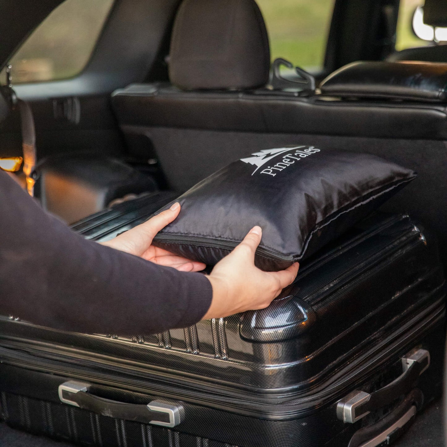 Travel Pillow loaded into trunk with different types of luggage
