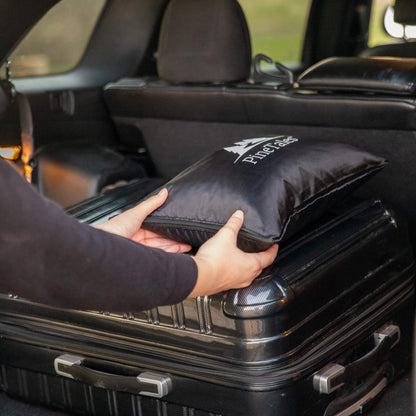 Travel Pillow loaded into trunk with different types of luggage