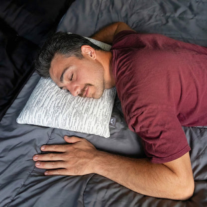 Young man using stomach sleeper pillow with matrix design bamboo cover