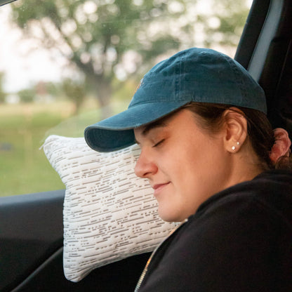 Young Woman using the travel pillow in the car